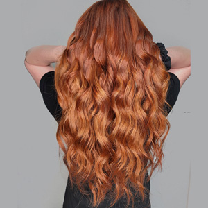 Hair extensions with fiery, copper tone waves